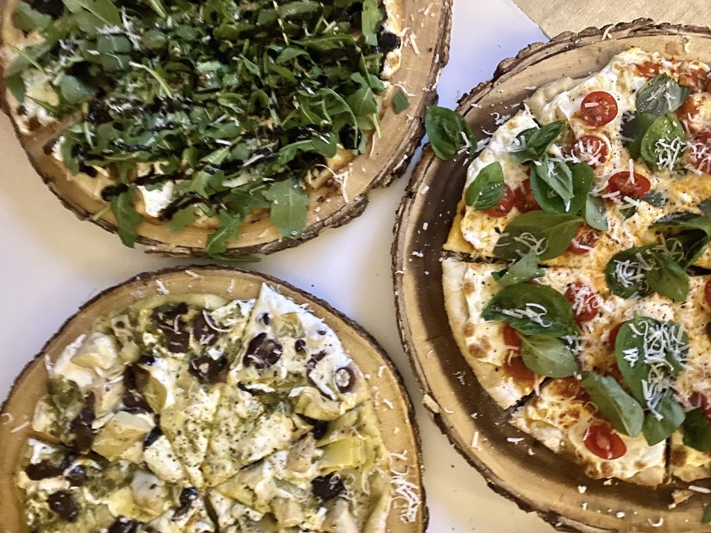 close up of three different kinds of pizza